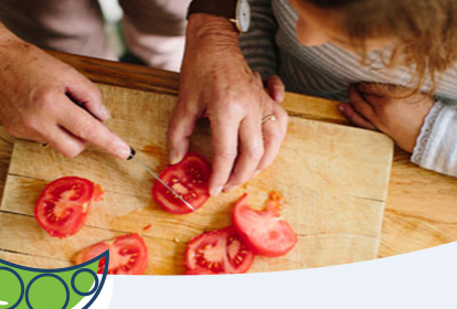 father and daughter slicing tomatoes