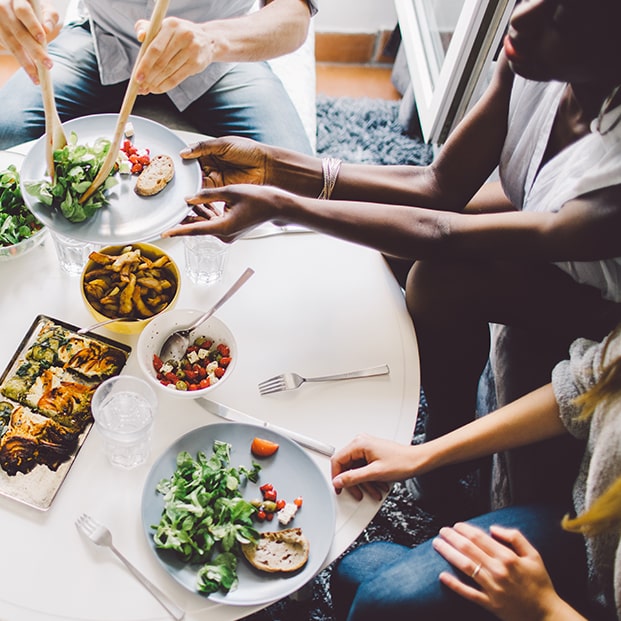 Family eating meal around table